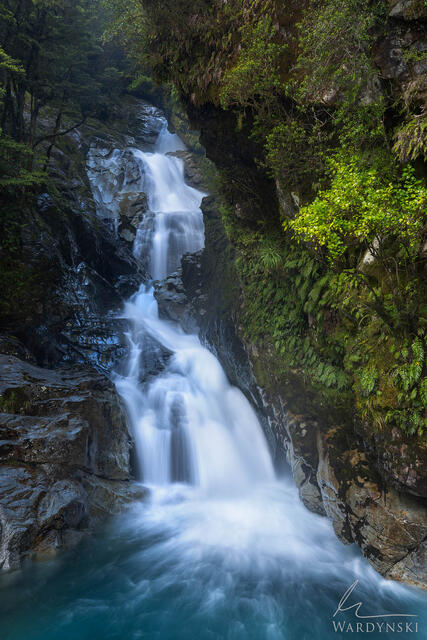 Vibrant fine art photograph of a waterfall in Fiordland National Park, New Zealand.
